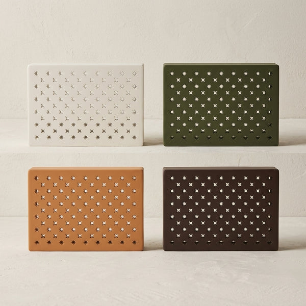 Stars doorbell chime covers in white, green, caramel and dark brown with a grid of star cutouts