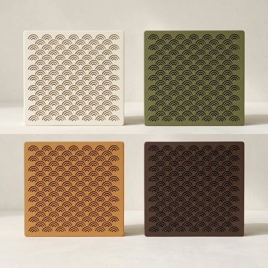 Arches doorbell chime covers in white, green, caramel and dark brown, showing the stacked-arch pattern