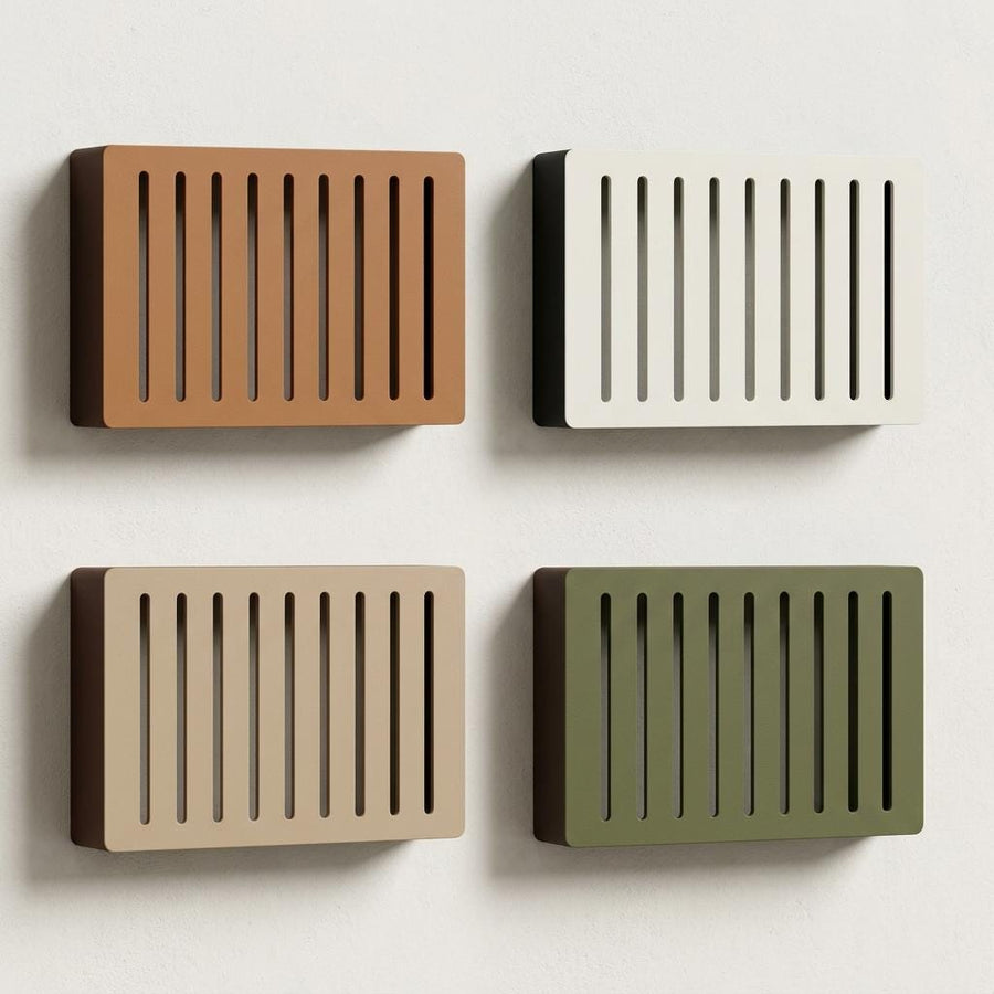 Four Two-Tone Louver doorbell chime covers on a wall, each with a colored face and a darker body