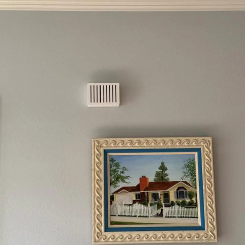 White Louver chime cover above a framed painting of a house