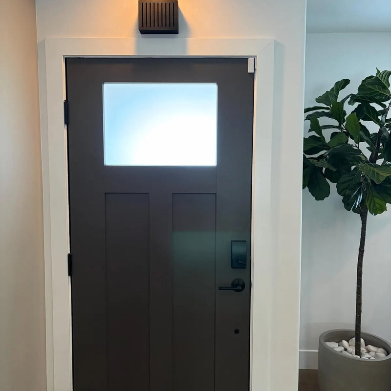 Dark brown Louver chime cover mounted above a dark front door